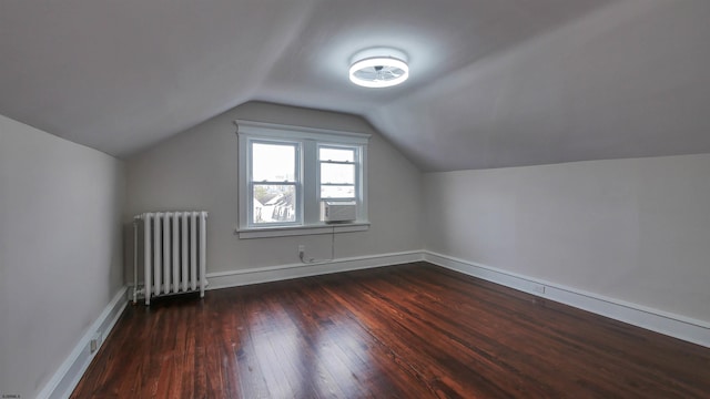 bonus room featuring radiator, lofted ceiling, and dark hardwood / wood-style flooring