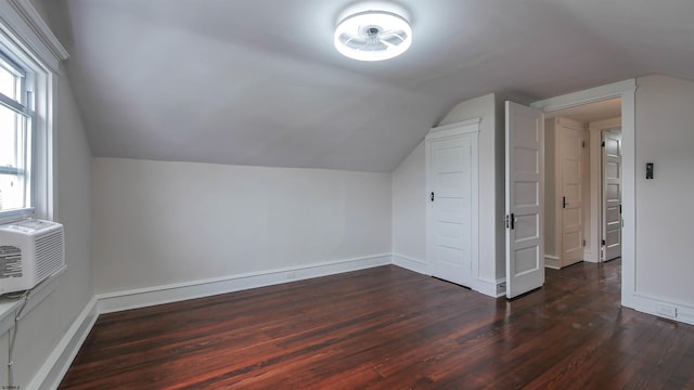 bonus room with lofted ceiling and dark wood-type flooring