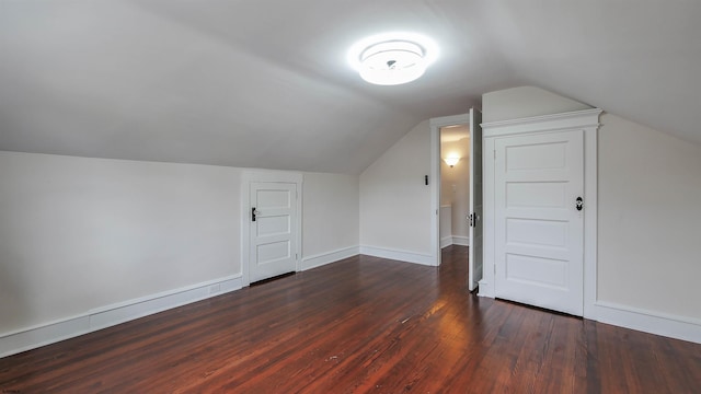 additional living space with lofted ceiling and dark hardwood / wood-style floors