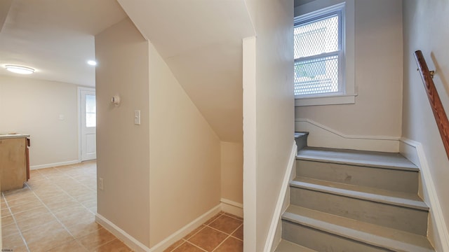 stairs featuring a healthy amount of sunlight and tile patterned flooring