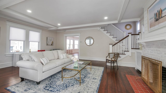 living room featuring ornamental molding, a brick fireplace, and dark hardwood / wood-style flooring