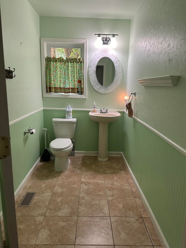 bathroom featuring tile patterned flooring and toilet