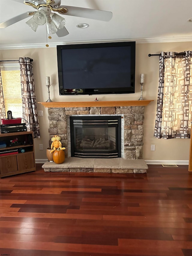 interior details with ornamental molding, hardwood / wood-style flooring, a fireplace, and ceiling fan