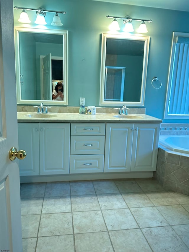 bathroom featuring vanity, shower with separate bathtub, and tile patterned floors