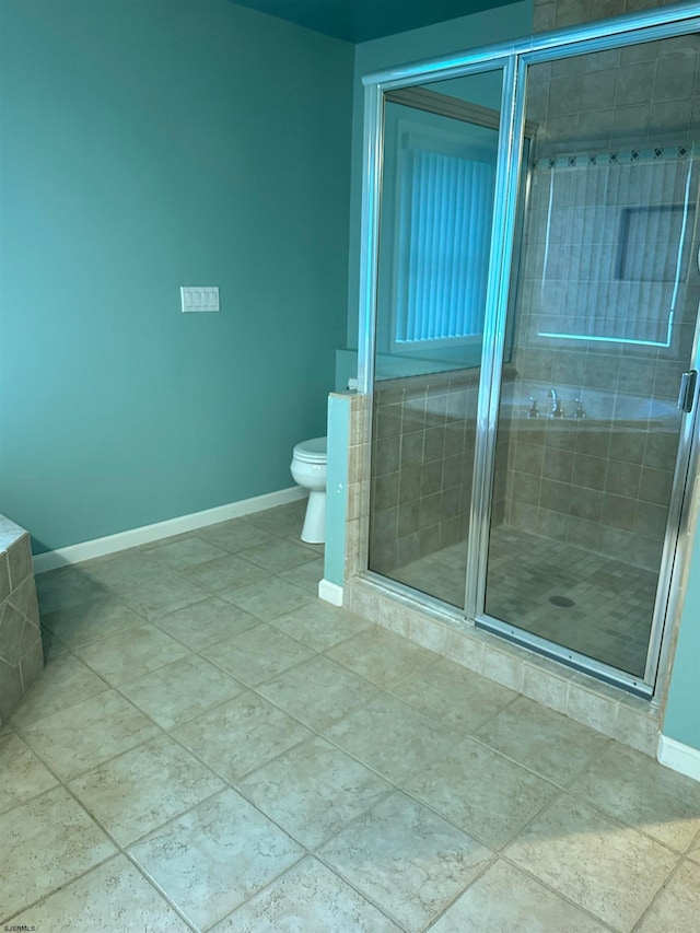 bathroom featuring toilet and a shower with shower door