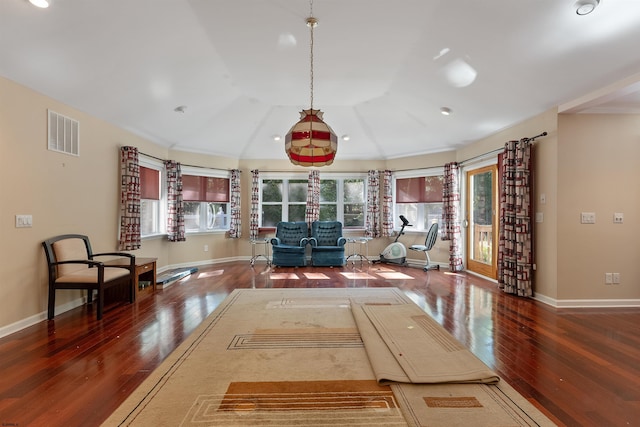 interior space with dark hardwood / wood-style floors, vaulted ceiling, and ornamental molding