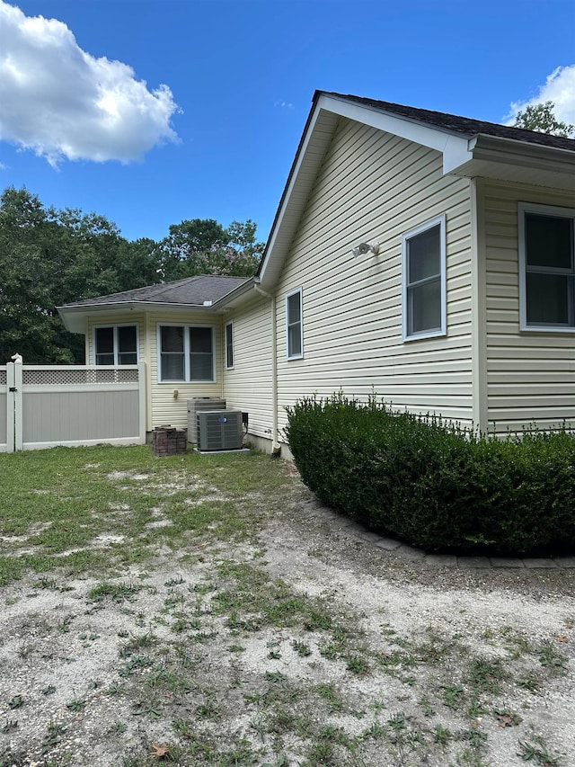 rear view of house featuring central AC unit