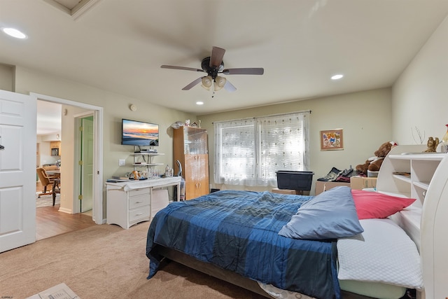 bedroom with ceiling fan and light colored carpet