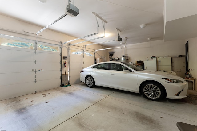 garage featuring a garage door opener and white fridge