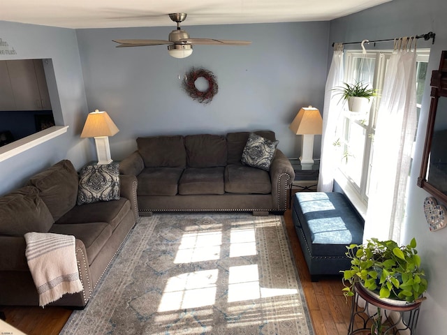 living room with dark wood-type flooring and ceiling fan