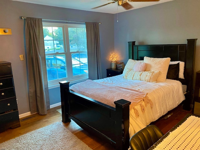 bedroom with light hardwood / wood-style floors and ceiling fan