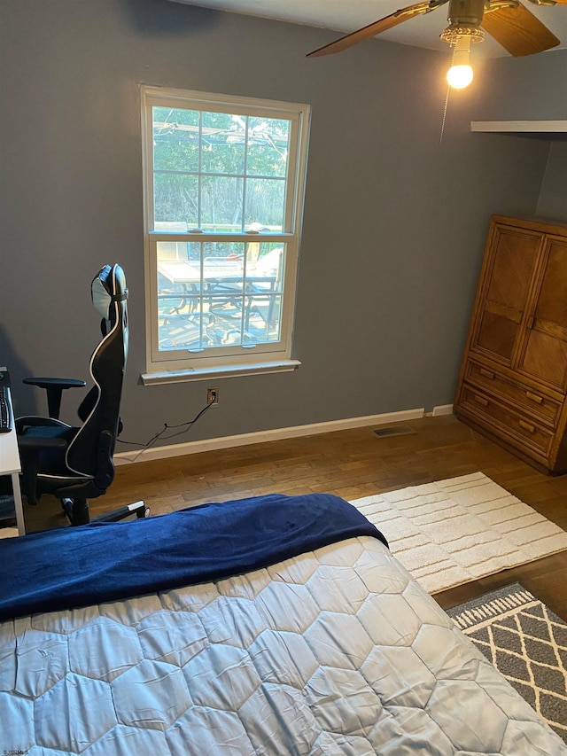 bedroom with ceiling fan and hardwood / wood-style floors