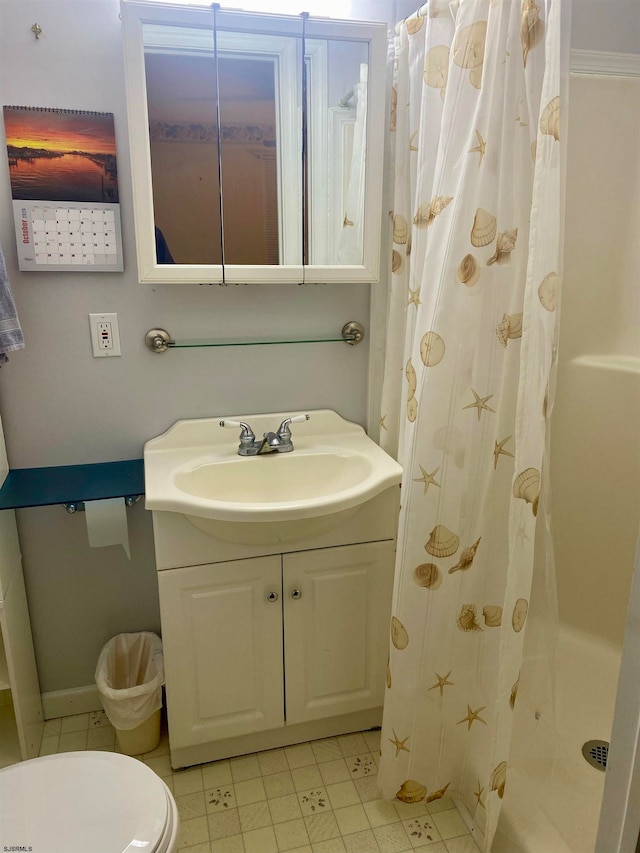 bathroom with toilet, vanity, and a shower with shower curtain