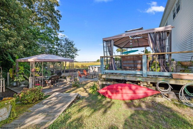 view of yard with a gazebo and a wooden deck