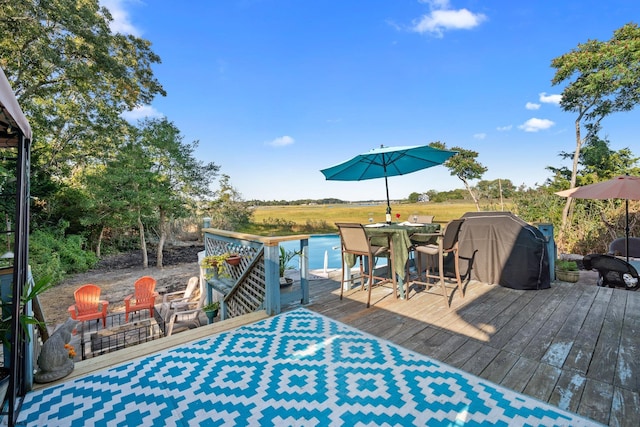 wooden terrace featuring a water view