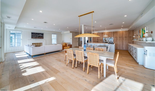 109 S 11th Ave, Longport, NJ 08403 - dining space with light wood-style floors, a fireplace, and recessed lighting