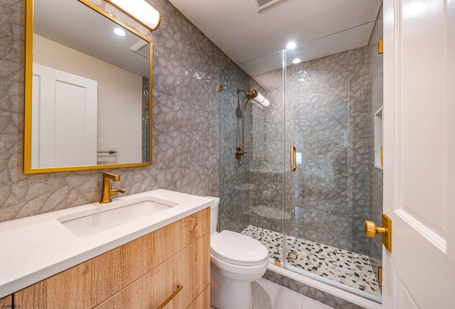 109 S 11th Ave, Longport, NJ 08403 - bathroom with tile walls, toilet, a stall shower, vanity, and tile patterned flooring