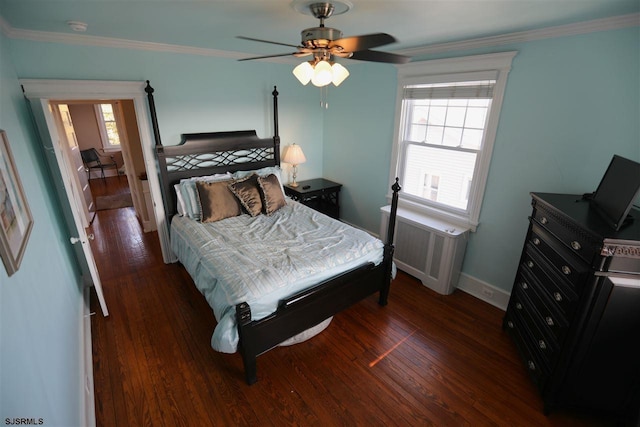 bedroom with ornamental molding, ceiling fan, radiator, and dark hardwood / wood-style flooring