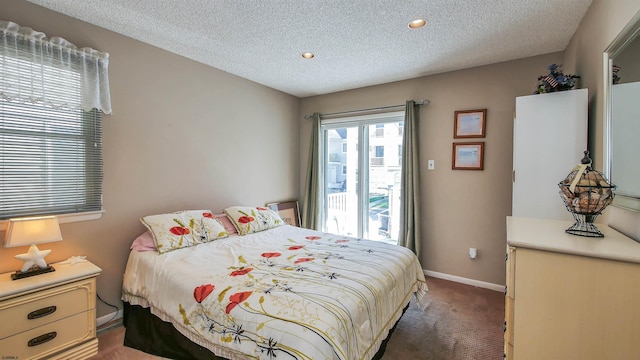 carpeted bedroom featuring a textured ceiling