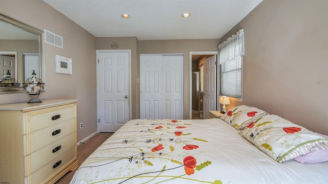 carpeted bedroom featuring a textured ceiling