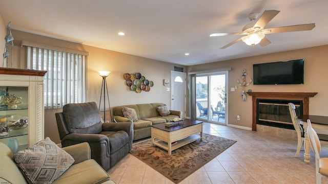 living room with light tile patterned flooring and ceiling fan