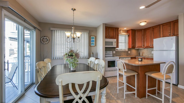 dining room featuring light tile patterned flooring, a notable chandelier, and a wealth of natural light