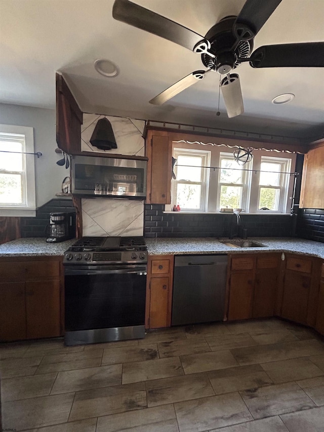 kitchen featuring stainless steel appliances, plenty of natural light, and decorative backsplash