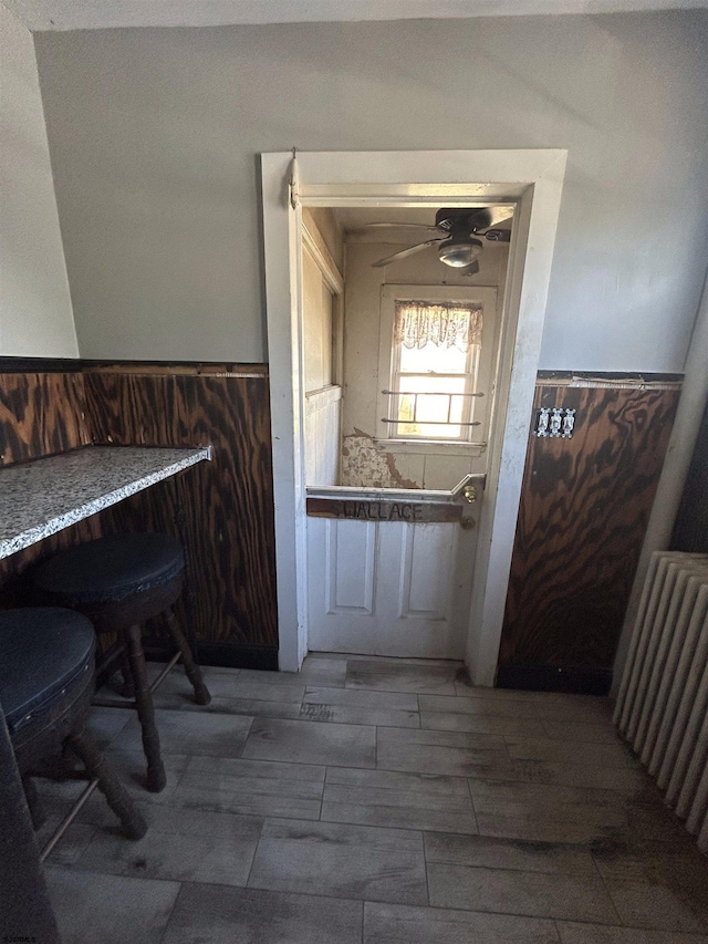 interior space with radiator heating unit and hardwood / wood-style flooring