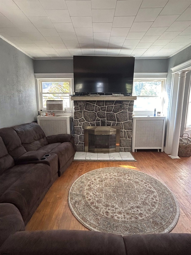 living room with a fireplace, plenty of natural light, and hardwood / wood-style floors