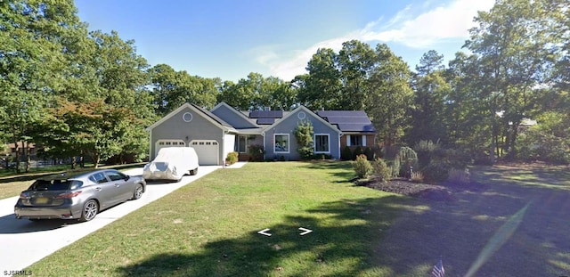 single story home featuring a front yard, a garage, and solar panels