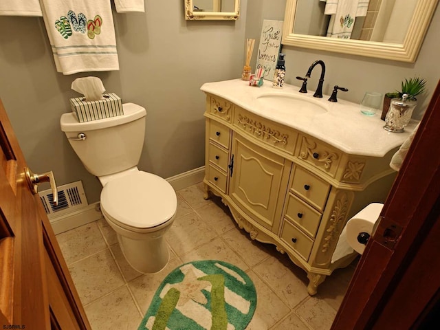 bathroom featuring vanity, tile patterned flooring, and toilet