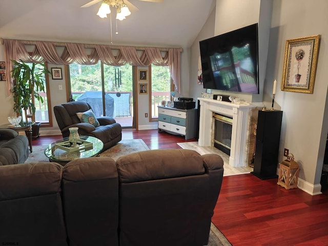 living room featuring ceiling fan, vaulted ceiling, a fireplace, and hardwood / wood-style floors