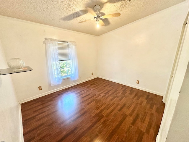 empty room featuring ceiling fan, dark hardwood / wood-style flooring, a textured ceiling, and ornamental molding