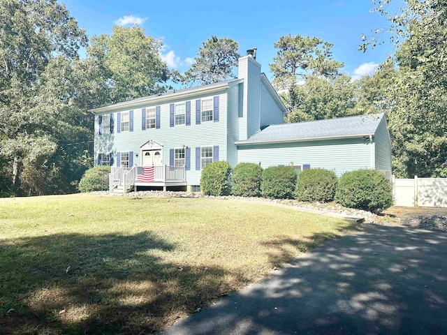 colonial-style house with a front lawn