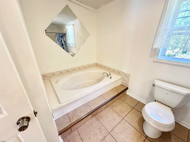 bathroom featuring tile patterned floors, a washtub, plenty of natural light, and toilet