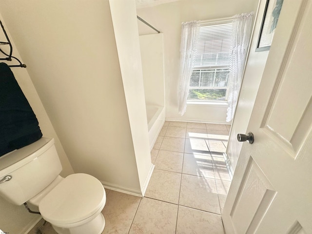 bathroom with tile patterned flooring, toilet, and bathtub / shower combination