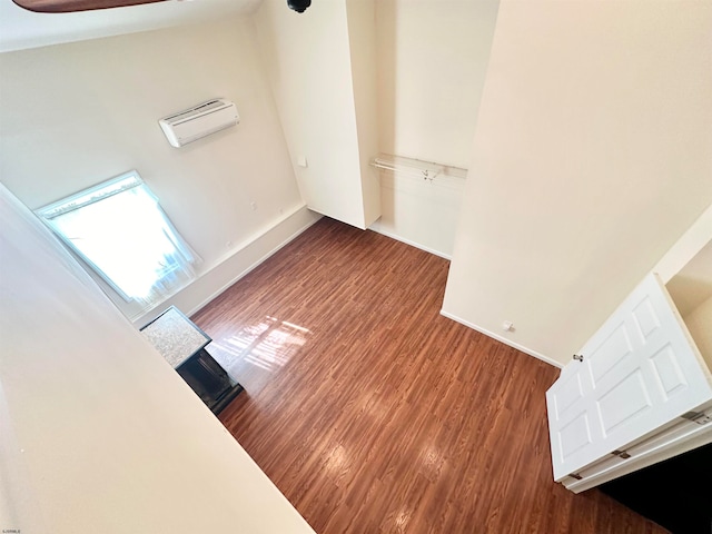 interior space featuring a towering ceiling and dark hardwood / wood-style flooring