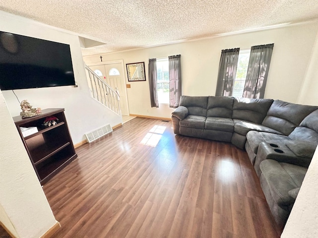 living room with hardwood / wood-style floors and a textured ceiling