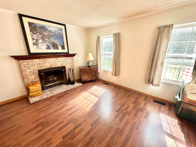 living room with hardwood / wood-style floors, a fireplace, and a textured ceiling