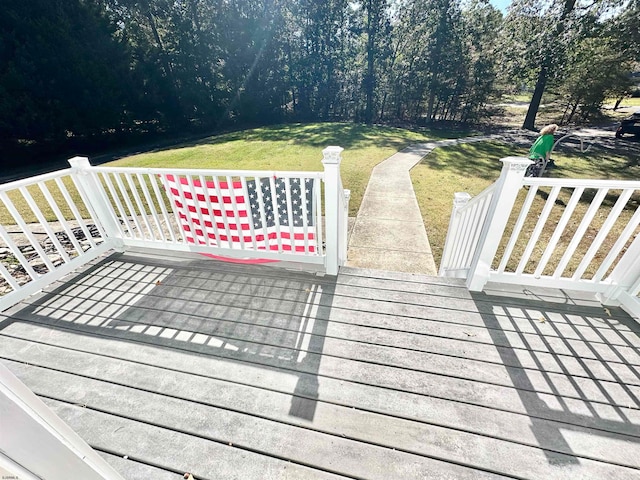 wooden deck with a lawn