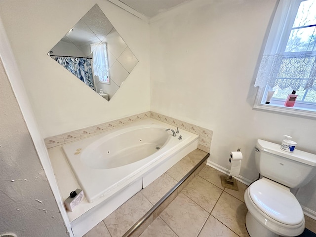 bathroom featuring tiled tub, tile patterned flooring, and toilet