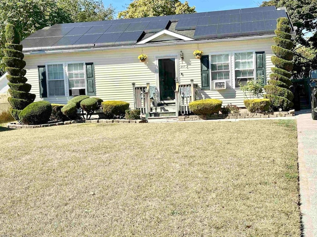 view of front facade with solar panels and a front yard