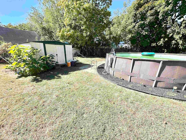 view of yard featuring a fenced in pool and a storage shed