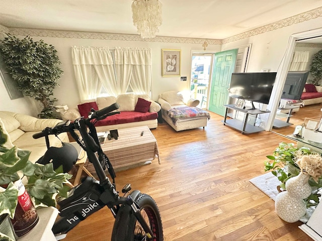 living room with a notable chandelier and wood-type flooring