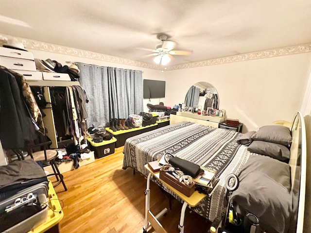 bedroom with hardwood / wood-style flooring and ceiling fan