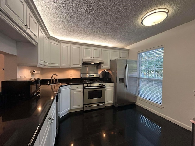 kitchen with white cabinets, a textured ceiling, stainless steel appliances, and sink