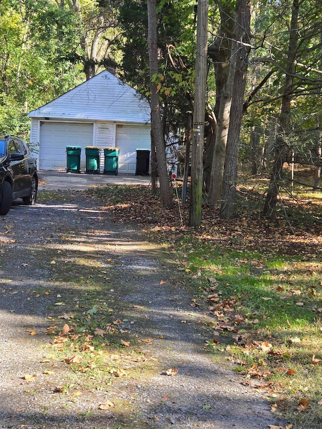 view of property exterior with a garage and an outdoor structure