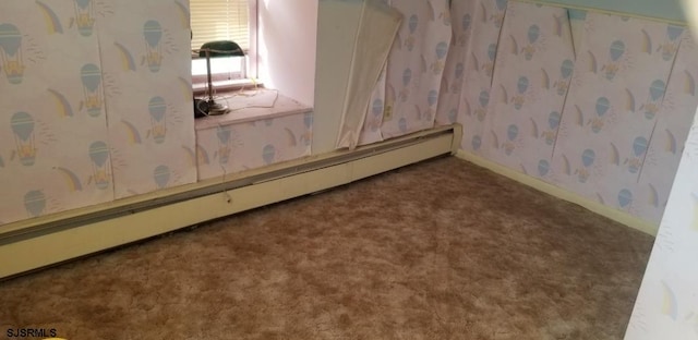 carpeted spare room with baseboard heating