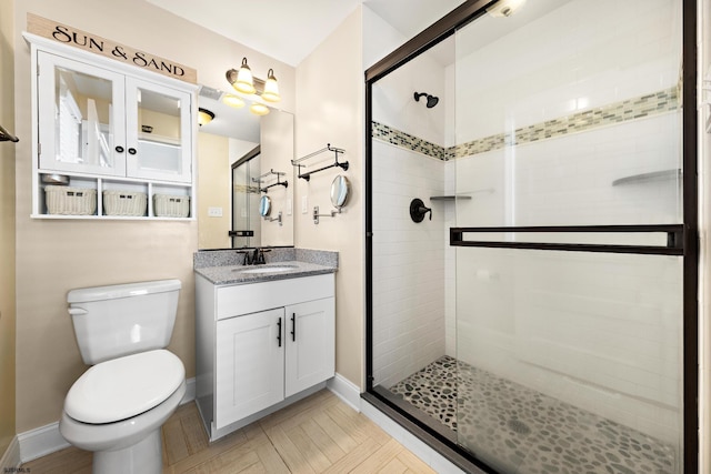 bathroom with vanity, walk in shower, and toilet