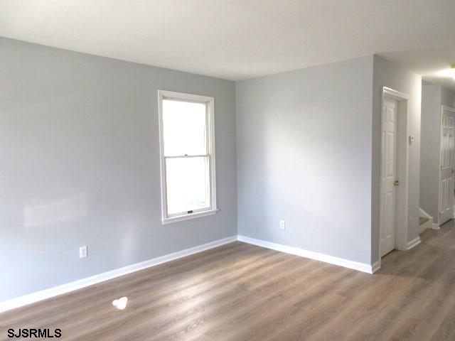 empty room featuring wood-type flooring